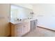 Bathroom with double vanity, large mirror, and tiled floor at 5085 Bone Ln, Brooksville, FL 34604