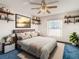 Bedroom with large bed, ceiling fan, and shelves at 5085 Bone Ln, Brooksville, FL 34604