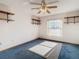 Bright bedroom with ceiling fan and blue carpet at 5085 Bone Ln, Brooksville, FL 34604