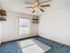 Bedroom featuring a ceiling fan and blue carpet at 5085 Bone Ln, Brooksville, FL 34604