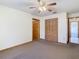 Spacious bedroom with ceiling fan and double doors at 5085 Bone Ln, Brooksville, FL 34604