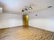 Game room with wood floors, cabinets, and a door at 5085 Bone Ln, Brooksville, FL 34604