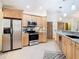 Modern kitchen with stainless steel appliances and wood cabinets at 5085 Bone Ln, Brooksville, FL 34604