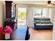 Bright living room featuring hardwood floors, a gray sofa, and a large antique cabinet at 5945 21St N St # 2, St Petersburg, FL 33714