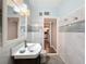 Bathroom with vanity, toilet, and view into kitchen at 6827 Sanderling Ln, Hudson, FL 34667