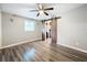 Bedroom with wood-look floors and barn door to closet at 6827 Sanderling Ln, Hudson, FL 34667