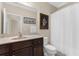 Bathroom with a dark wood vanity, a white shower curtain, and artwork on the wall at 692 Challice Dr, Spring Hill, FL 34609