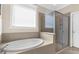 Bright bathroom featuring a soaking tub next to a glass enclosed shower at 692 Challice Dr, Spring Hill, FL 34609