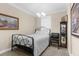 Cozy bedroom with an iron frame bed, a window, and vintage decor at 692 Challice Dr, Spring Hill, FL 34609