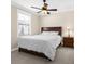 Comfortable bedroom with a large window, ceiling fan, and bedside table at 692 Challice Dr, Spring Hill, FL 34609