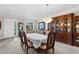 Formal dining room with a large china cabinet, chandelier, and seating for six at 692 Challice Dr, Spring Hill, FL 34609