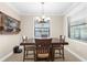 Dining room with a classic chandelier, neutral paint, and lots of natural light at 692 Challice Dr, Spring Hill, FL 34609