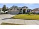 Charming home with a three car garage, manicured lawn, and a welcoming entrance at 692 Challice Dr, Spring Hill, FL 34609
