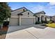 Well-maintained single-story home with a three-car garage and a large driveway at 692 Challice Dr, Spring Hill, FL 34609