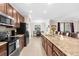 Spacious kitchen with stainless steel appliances and a breakfast bar overlooking dining at 692 Challice Dr, Spring Hill, FL 34609