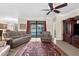 Comfortable living room with tile flooring, ceiling fan, and sliding glass doors to pool area at 692 Challice Dr, Spring Hill, FL 34609