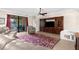 Open living room with sliding glass doors to the screened lanai, fan and hardwood entertainment center at 692 Challice Dr, Spring Hill, FL 34609
