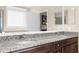 Bathroom featuring granite counters, dual sinks, and large vanity mirrors at 692 Challice Dr, Spring Hill, FL 34609