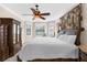 Cozy main bedroom with a ceiling fan, bay windows, and large furniture pieces at 692 Challice Dr, Spring Hill, FL 34609