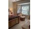 Main bedroom with a sitting area and large window at 7221 Cleopatra Dr, Land O Lakes, FL 34637
