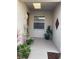 Front porch with potted plants and light fixture at 7221 Cleopatra Dr, Land O Lakes, FL 34637