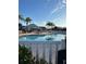 Community pool with lounge chairs and palm trees at 7221 Cleopatra Dr, Land O Lakes, FL 34637