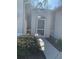 Screened side entrance with walkway and landscaping at 7221 Cleopatra Dr, Land O Lakes, FL 34637