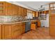 Detailed view of kitchen with wood cabinets and granite countertops at 7420 Hatteras Dr, Hudson, FL 34667