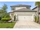 Two-story house with white exterior, a white garage door, and landscaping at 8287 Velda Trl, Sarasota, FL 34241