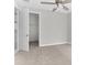 Well-lit bedroom with carpet, ceiling fan, and walk-in closet at 8290 40Th N St, Pinellas Park, FL 33781