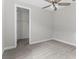 Bright bedroom featuring neutral walls, ceiling fan, and walk-in closet at 8290 40Th N St, Pinellas Park, FL 33781