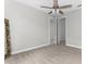 Bright bedroom with neutral walls, ceiling fan and large mirror at 8290 40Th N St, Pinellas Park, FL 33781