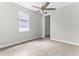 Spacious bedroom with neutral walls, ceiling fan, and plush carpeting at 8290 40Th N St, Pinellas Park, FL 33781