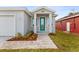 New home with a teal front door and paver walkway at 8290 40Th N St, Pinellas Park, FL 33781