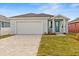 Newly constructed home with a teal front door and paver driveway at 8290 40Th N St, Pinellas Park, FL 33781