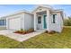 New home featuring a teal front door and paver driveway at 8290 40Th N St, Pinellas Park, FL 33781
