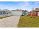 New construction home with teal front door and paver driveway at 8290 40Th N St, Pinellas Park, FL 33781