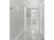 Clean hallway with white doors and marble-look flooring at 8290 40Th N St, Pinellas Park, FL 33781