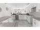 Modern kitchen with white cabinets, granite countertops, and marble flooring at 8290 40Th N St, Pinellas Park, FL 33781