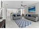 Bright living room featuring gray sofas, ceiling fan, and marble floors at 8290 40Th N St, Pinellas Park, FL 33781
