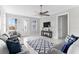 Living room with gray sofas, ceiling fan, and marble floors at 8290 40Th N St, Pinellas Park, FL 33781