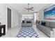Spacious living room with gray sofas, ceiling fan and marble floors at 8290 40Th N St, Pinellas Park, FL 33781