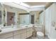 Clean bathroom, featuring a toilet, sink, shower, and large mirror at 8540 Caitlin Ct, Hudson, FL 34667