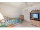 Charming bedroom with a single bed, built-in storage, and a TV at 8540 Caitlin Ct, Hudson, FL 34667