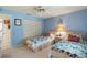 Serene bedroom with twin beds, ceiling fan, and access to a bath at 8540 Caitlin Ct, Hudson, FL 34667