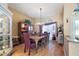 Formal dining room with hardwood floors, a large table, and plenty of natural light at 8540 Caitlin Ct, Hudson, FL 34667