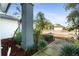 Landscaped front yard with a walkway to a charming home at 8540 Caitlin Ct, Hudson, FL 34667