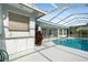 Outdoor kitchen area with sink and cabinets near the pool at 8540 Caitlin Ct, Hudson, FL 34667