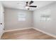 Bright bedroom with ceiling fan and neutral gray walls at 9240 Whitman Ln, Port Richey, FL 34668