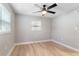 Simple bedroom with ceiling fan and neutral gray walls at 9240 Whitman Ln, Port Richey, FL 34668